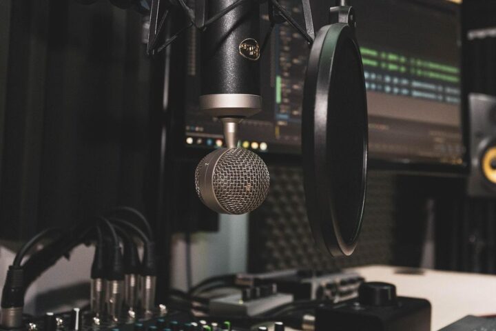 Studio microphone with pop filter in front of a recording setup