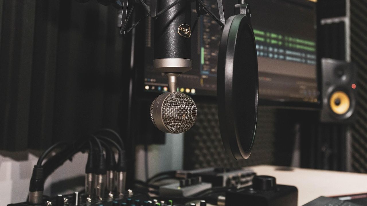 Studio microphone with pop filter in front of a recording setup