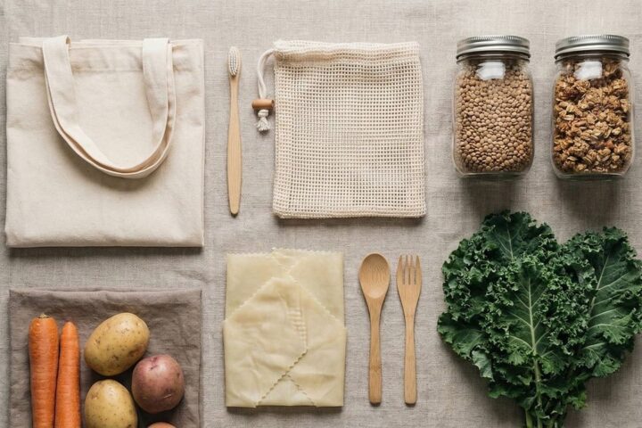 Reusable cotton bags, glass jars, bamboo cutlery and fresh vegetables