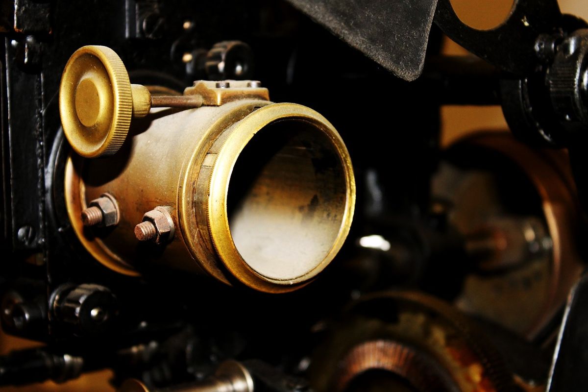 Close-up of the brass lens of an old cinema projector