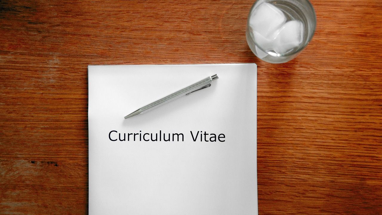 Sheet of paper titled Curriculum Vitae with a pen on a desk