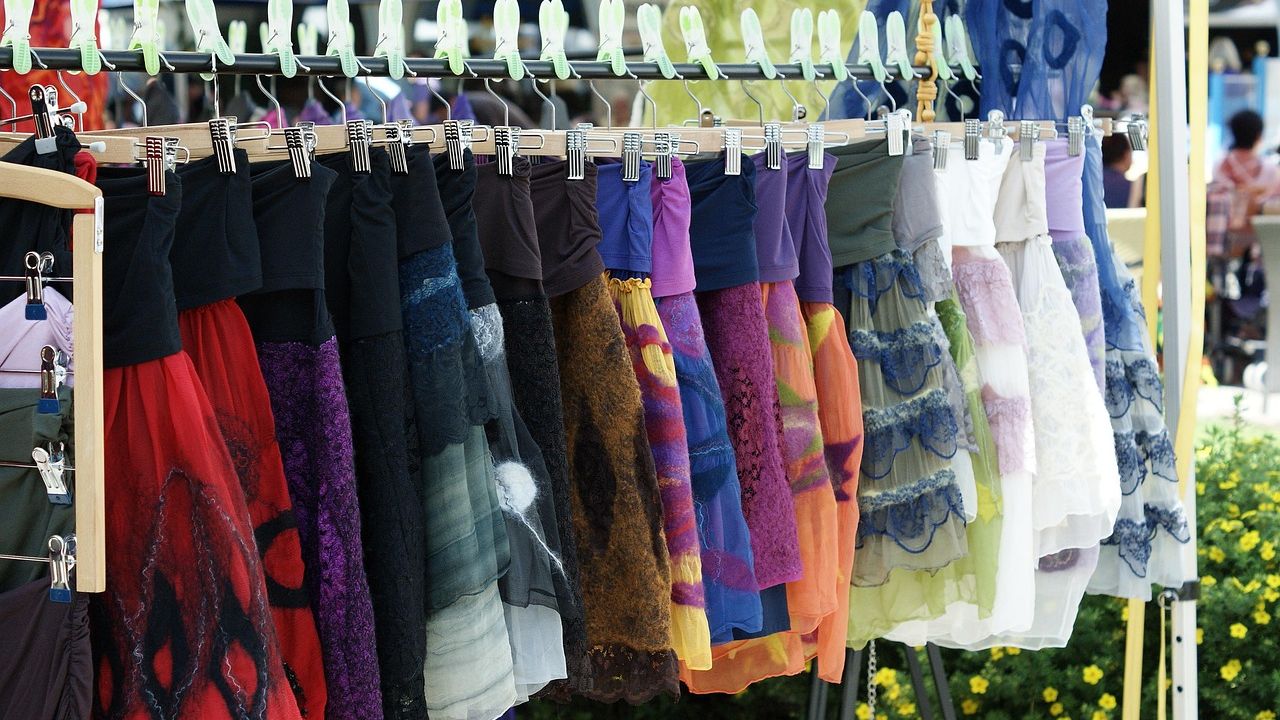 Rail of colourful summer skirts at a market stall