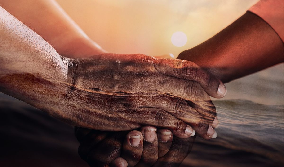 Two hands clasped together in support