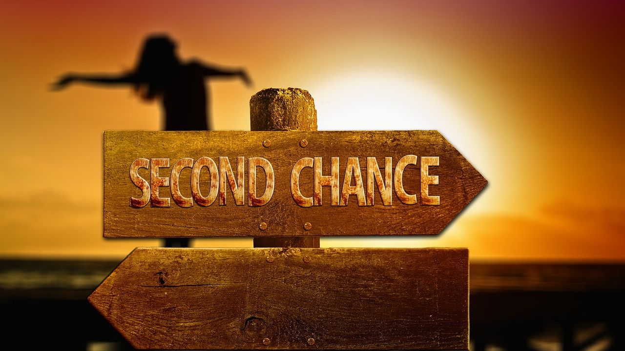 Signpost reading Second Chance against a sunset