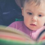 Toddler looking at a picture book