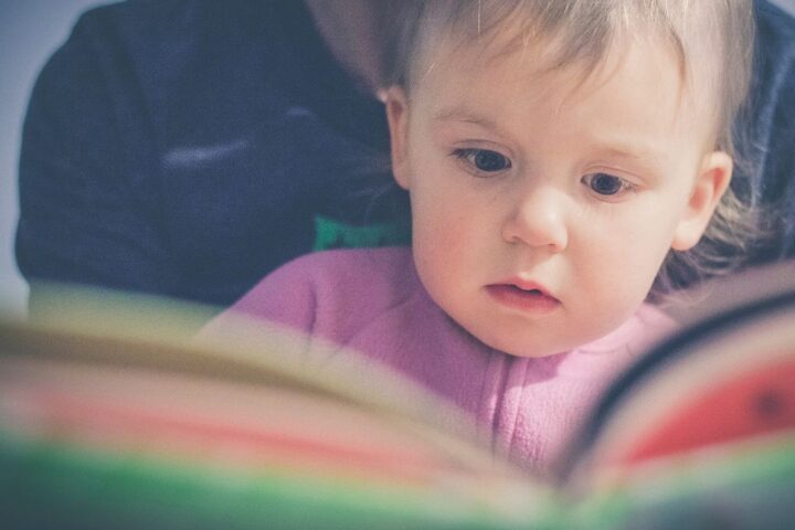 Toddler looking at a picture book