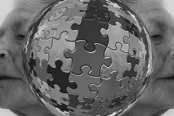 Jigsaw puzzle sphere between two faces in profile