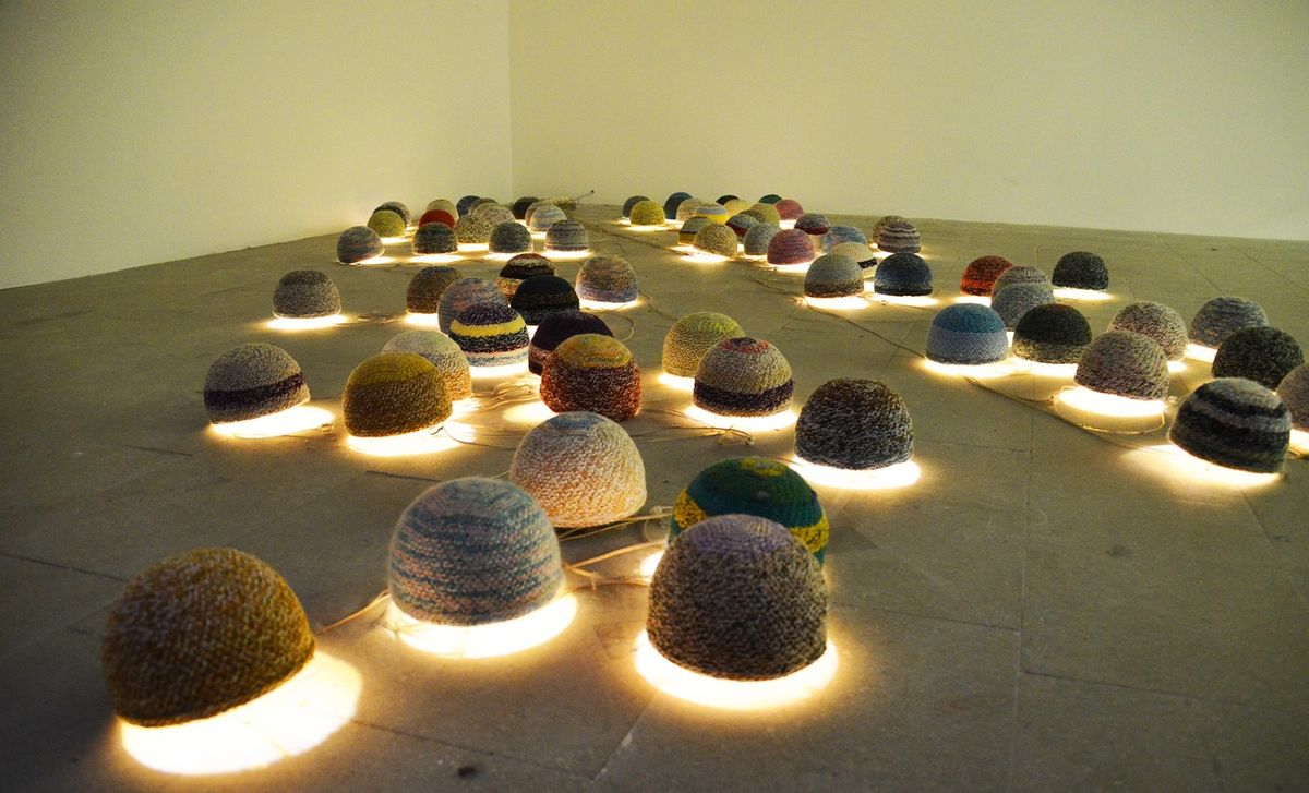 Gallery floor installation of glowing felt domes