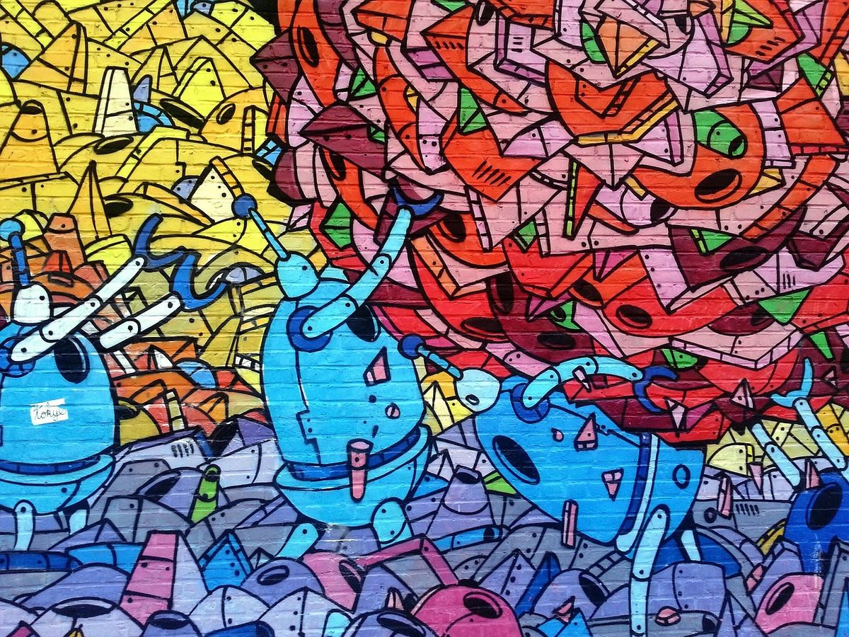 Wall covered in colourful cartoon-style street art