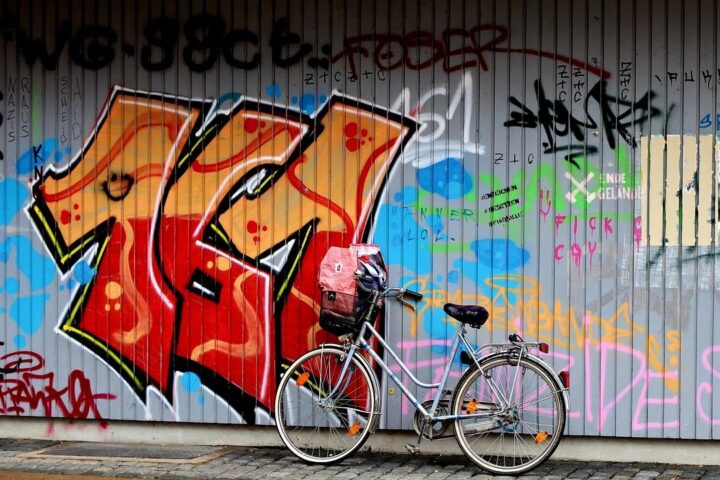 Bright graffiti mural on a shutter with a bicycle in front