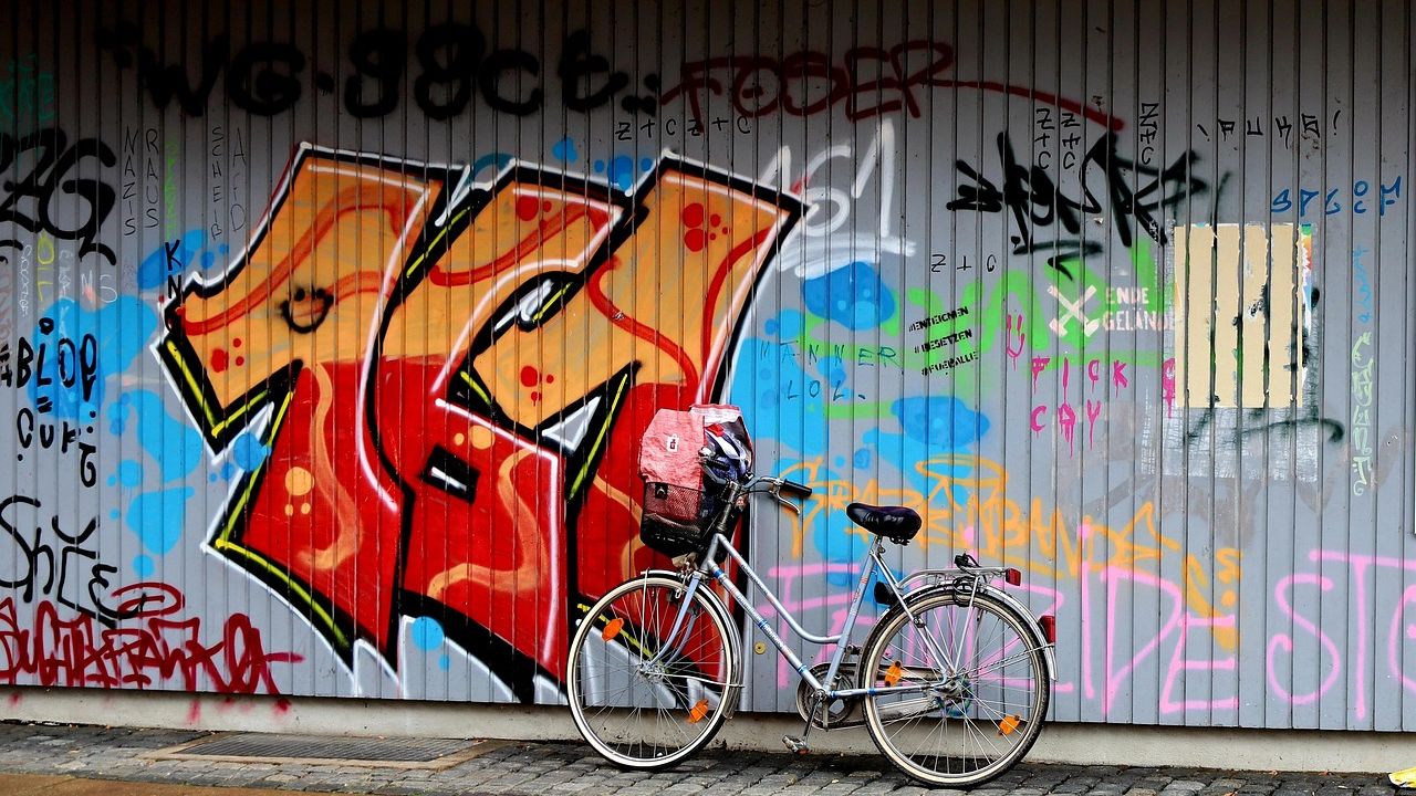 Bright graffiti mural on a shutter with a bicycle in front