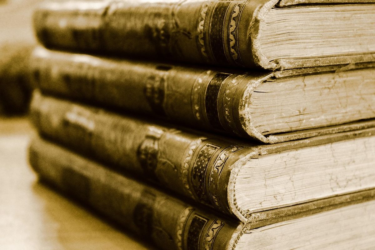 Stack of old books in warm sepia tones