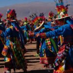 Dancers in colourful feathered costumes at a festival