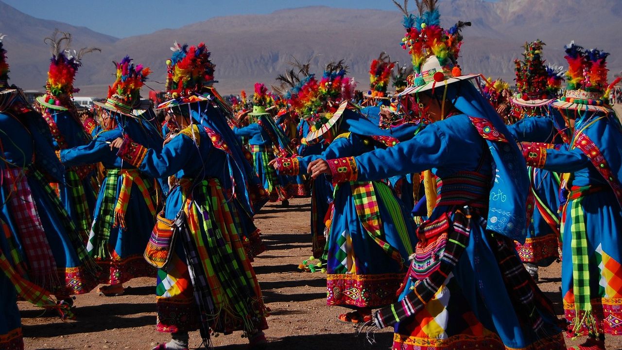 Dancers in colourful feathered costumes at a festival