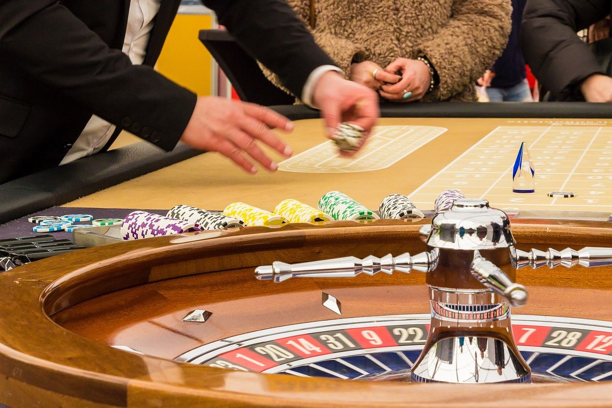 Croupier collecting chips at a casino roulette table