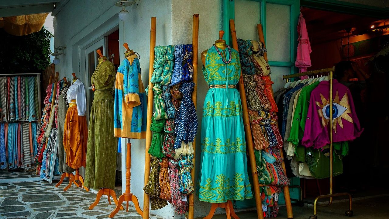Colourful dresses and fabrics in a small clothing boutique