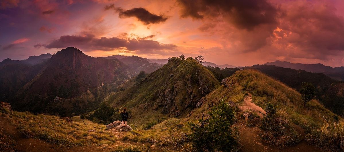 Sunset over rolling mountain ridges