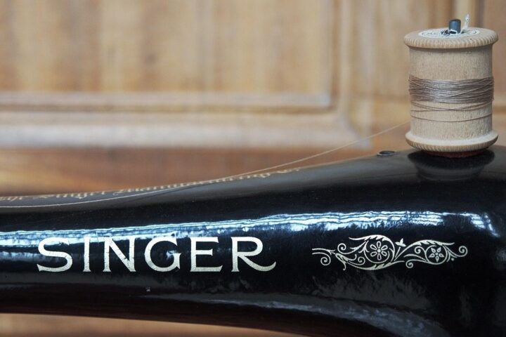 Close-up of a vintage Singer sewing machine with thread