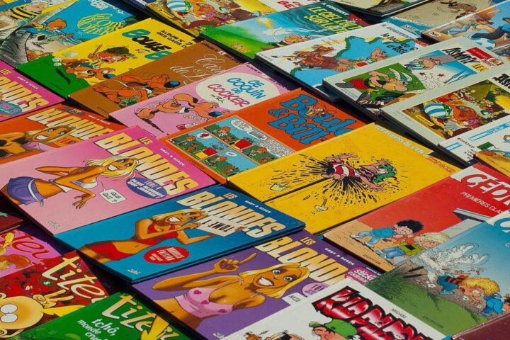 Colourful comic books spread out in overlapping piles