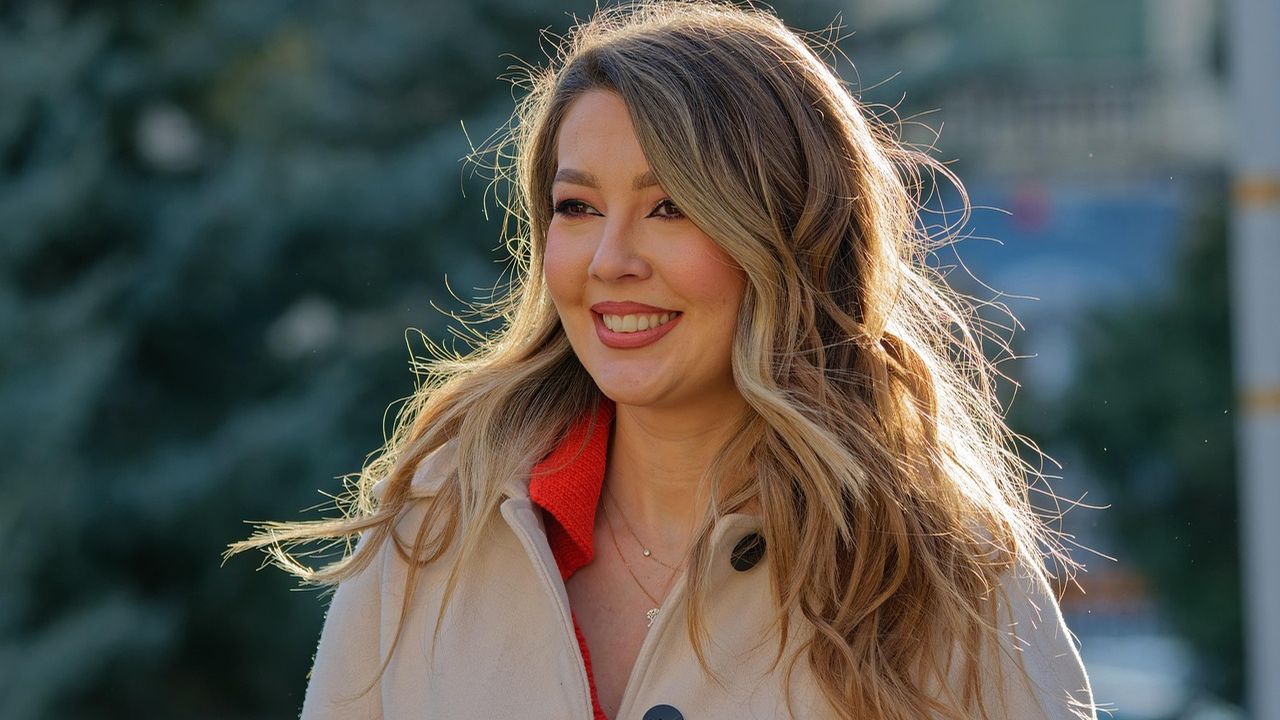 Smiling woman with long hair outdoors