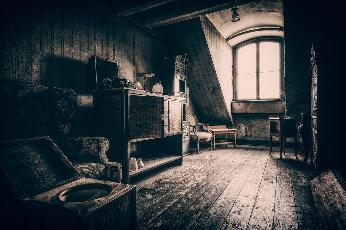 Dusty attic room full of old furniture and forgotten things