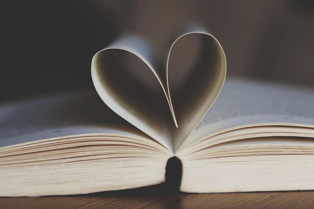 Open book with pages folded into a heart