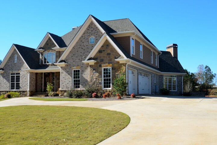 Large stone and brick family house with a lawn