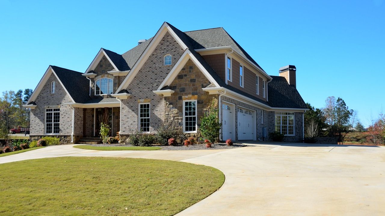 Large stone and brick family house with a lawn