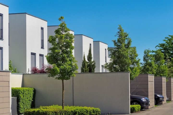 Row of modern white townhouses on a quiet street