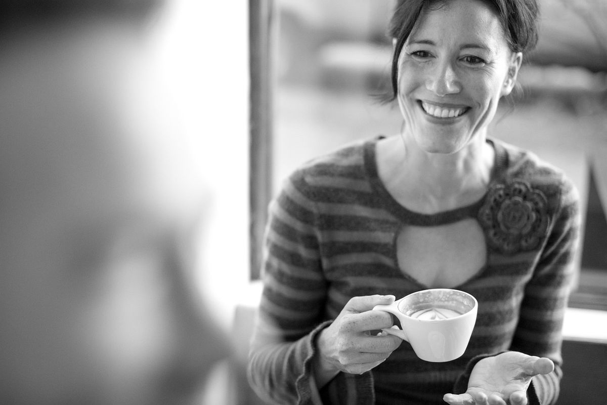 Smiling woman holding a cup of coffee