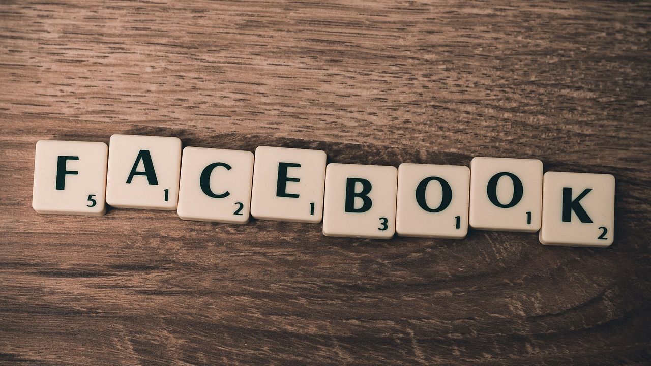 Scrabble tiles spelling Facebook on a wooden table