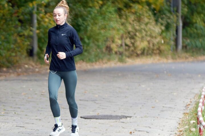 Woman jogging along a park path
