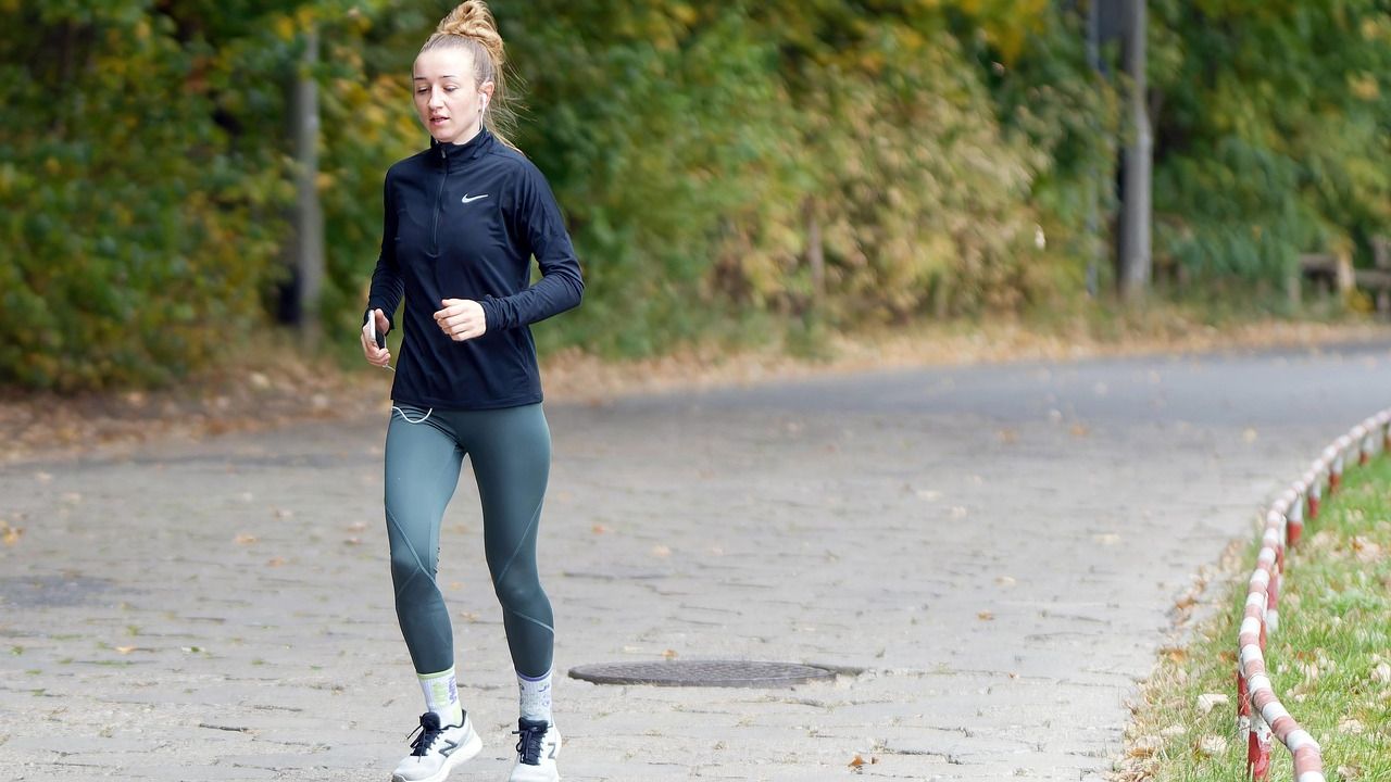 Woman jogging along a park path