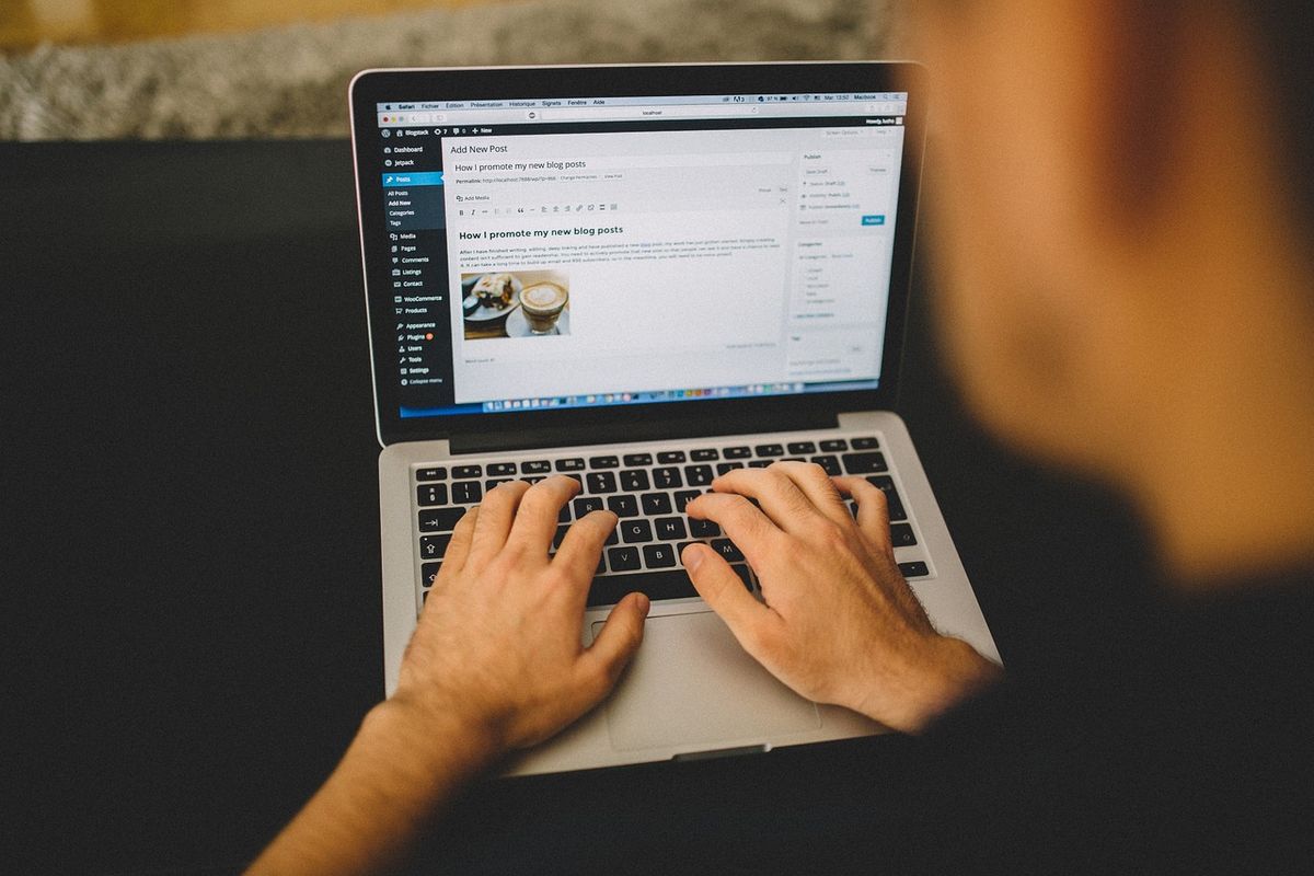 Writer typing on a laptop
