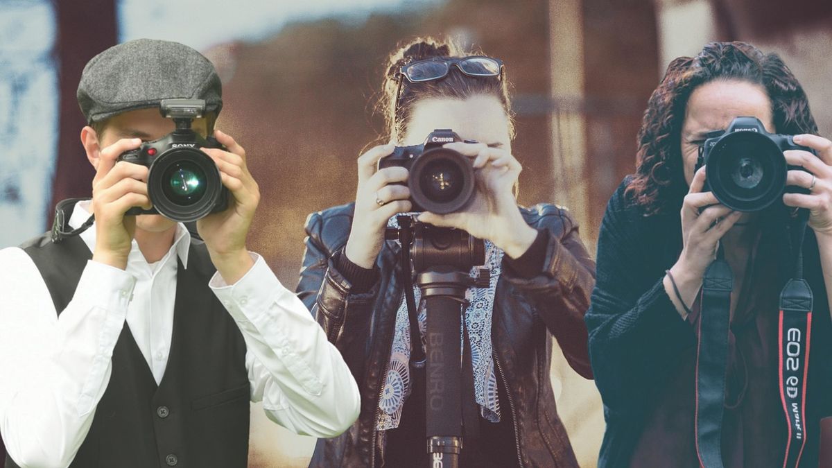 Three photographers aiming their cameras