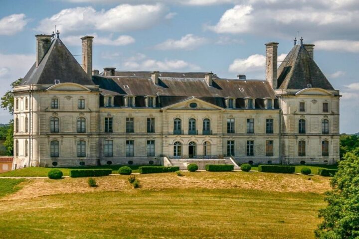 Grand French château with slate roofs above green lawns