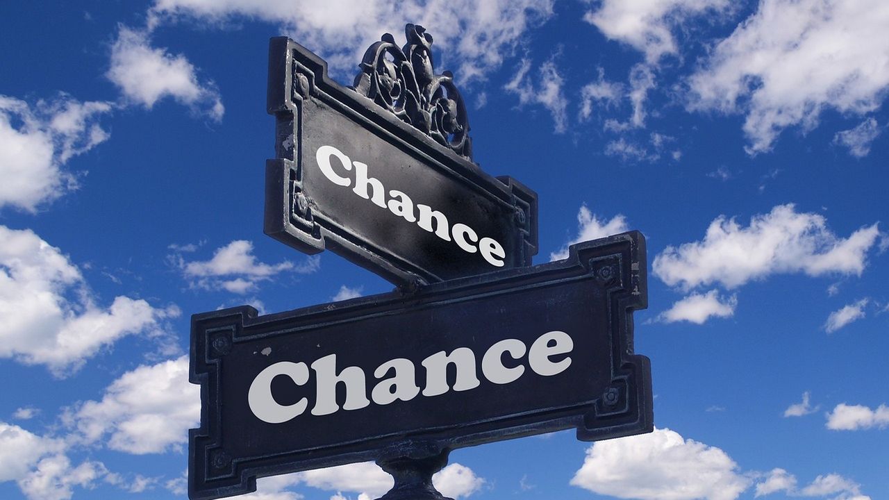 Ornate street sign reading Chance against a blue sky