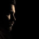 Profiles of a man and a woman in dramatic shadow