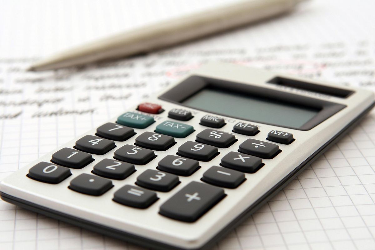 Calculator and pencil on squared paper
