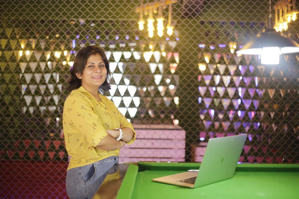 Smiling businesswoman standing in a decorated co-working space
