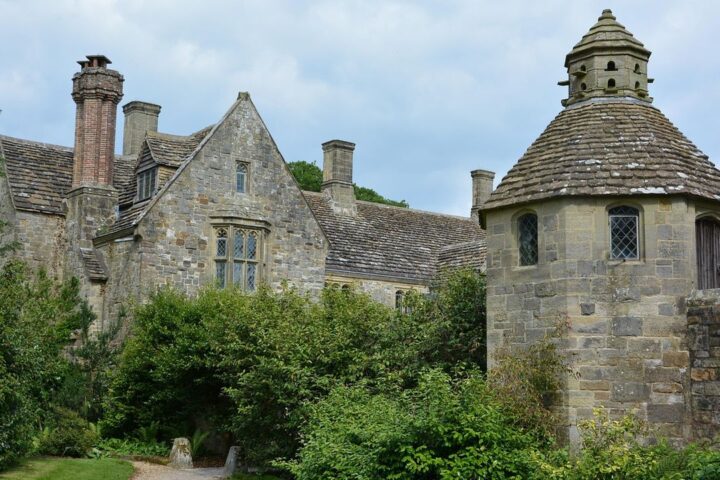 Old stone manor house with a dovecote and garden