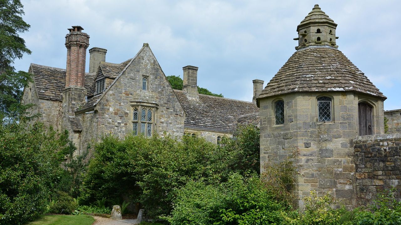 Old stone manor house with a dovecote and garden