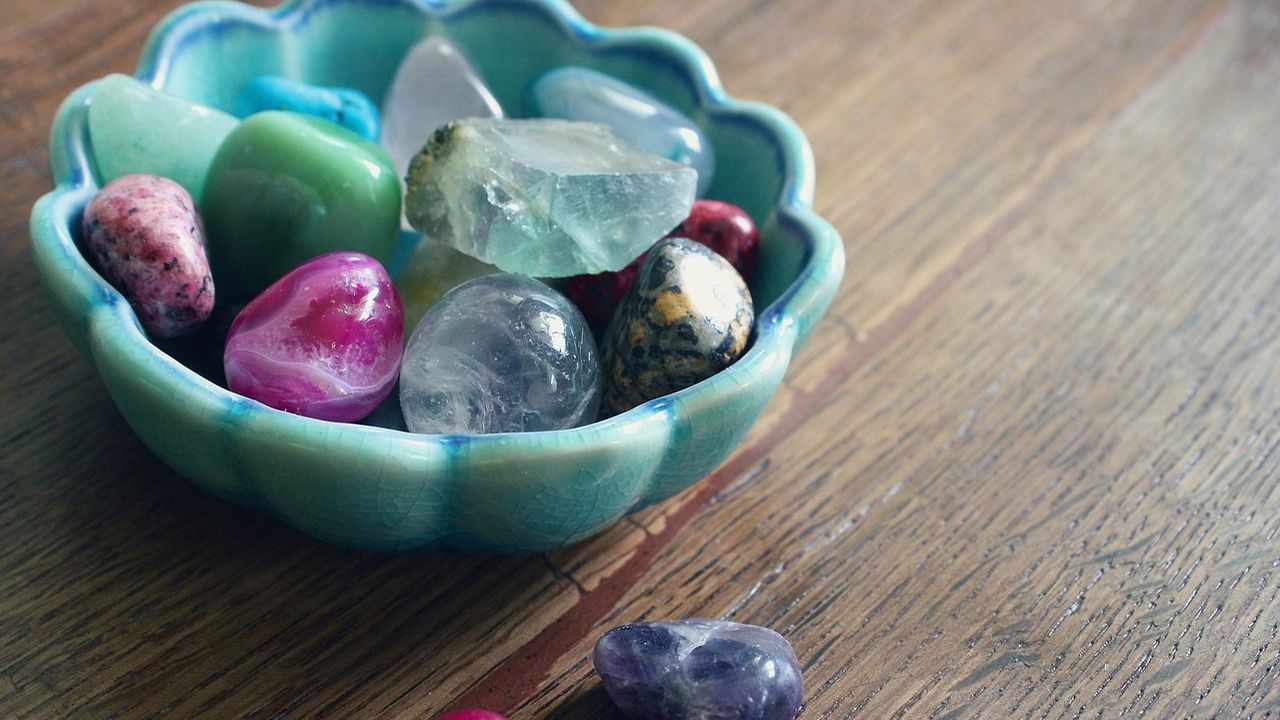 Bowl of polished healing crystals and gemstones