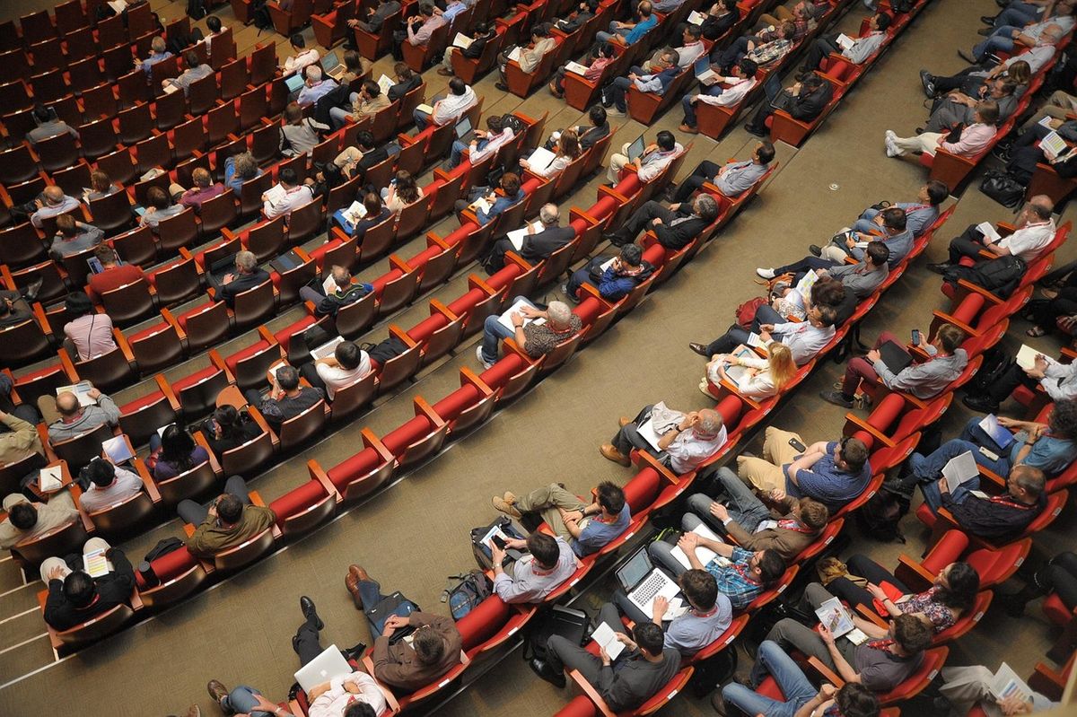 Large audience seated in an auditorium