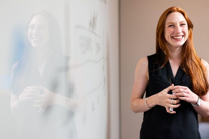 Smiling woman with red hair in a bright office