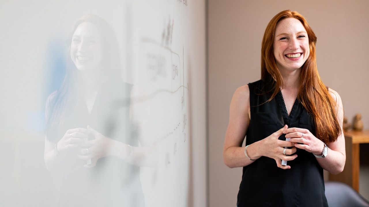 Smiling woman with red hair in a bright office