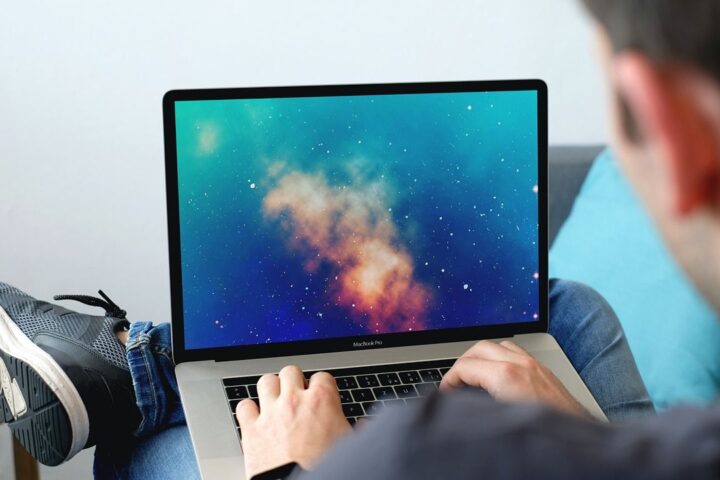 Man working on a laptop with his feet up at home