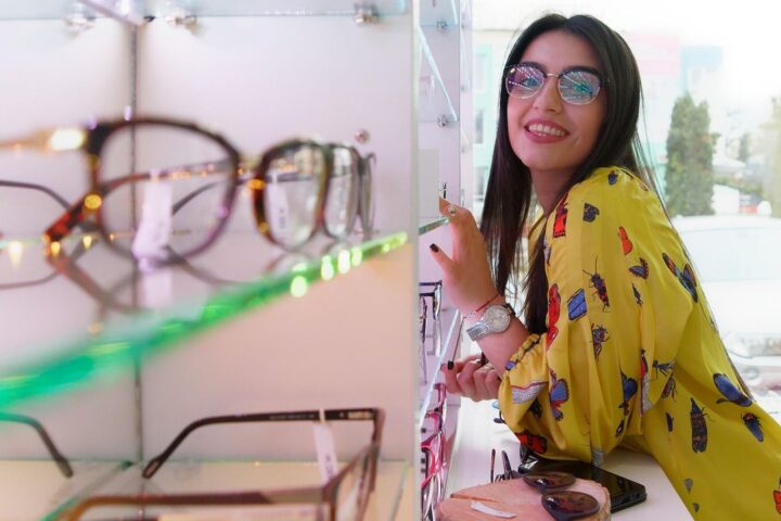 Woman trying on glasses at an optician's