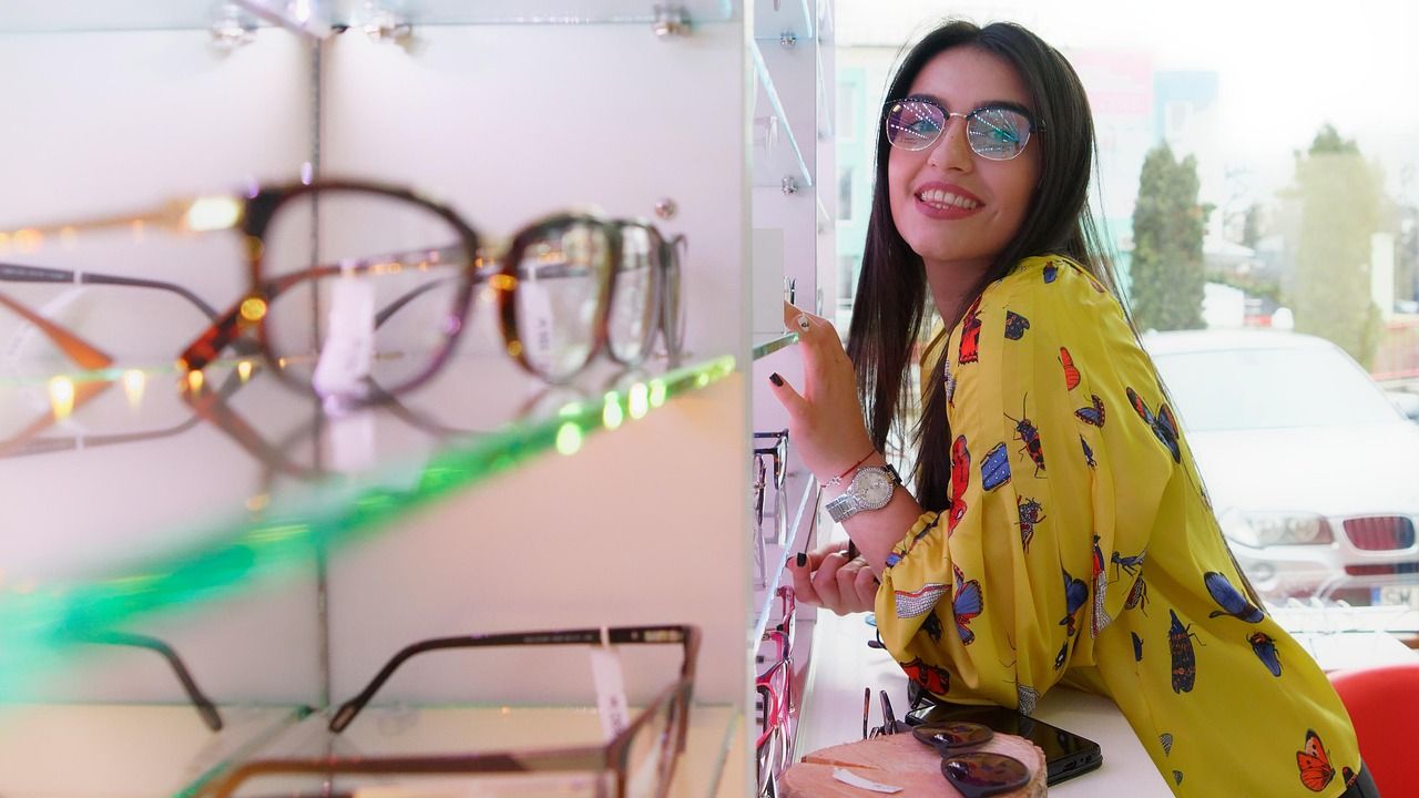 Woman trying on glasses at an optician's