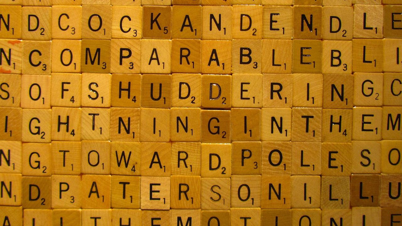 Wooden letter tiles forming a grid of words